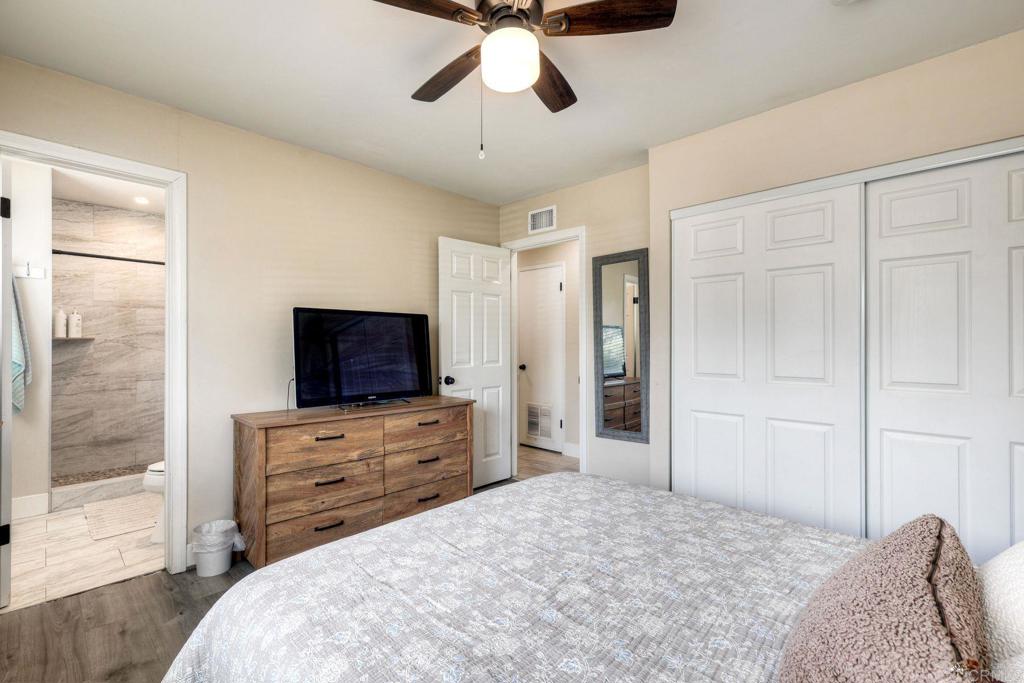 924 Daisy Street Escondido, CA 92027 - Photo 16 of 25 a bedroom with a bed and a flat tv screen on dresser
