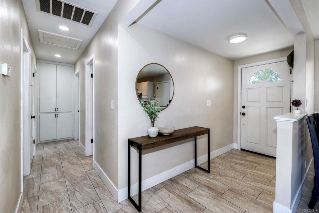 924 Daisy Street Escondido, CA 92027 - Photo 2 of 25 a view of a hallway with entryway wooden floor and front door