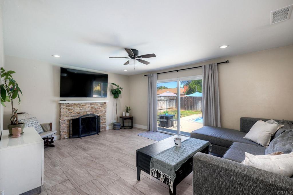 924 Daisy Street Escondido, CA 92027 - Photo 8 of 25 a living room with furniture a fireplace and a flat screen tv