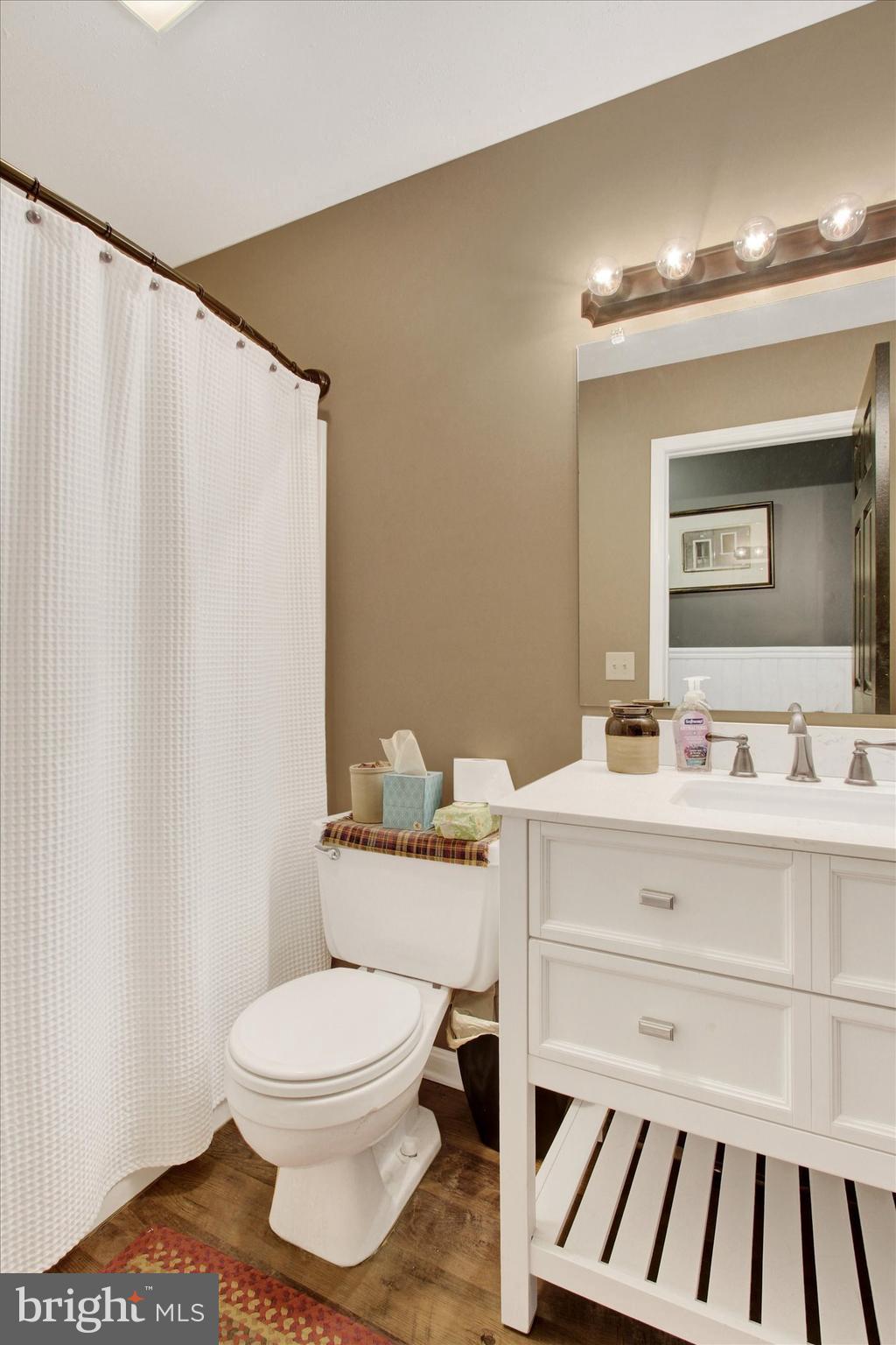 2790 Butternut Lane York, PA 17408 - Photo 10 of 30 a bathroom with a toilet a sink and a mirror