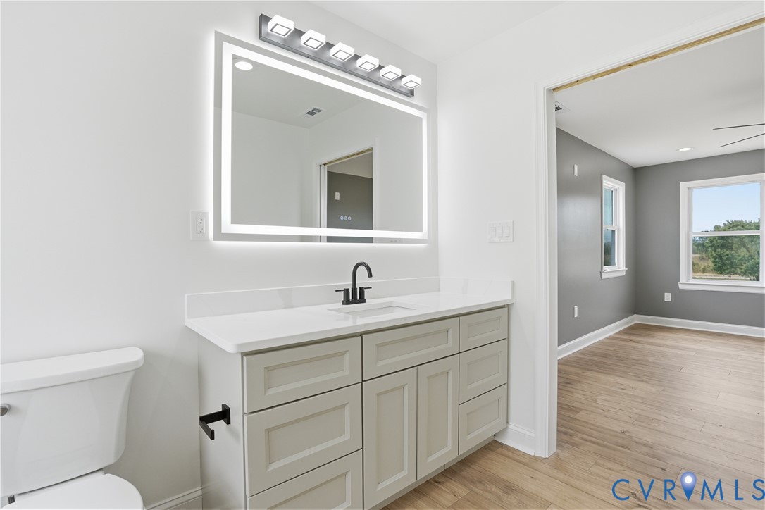 7839 King William Road Aylett, VA 23009 - Photo 21 of 38 a bathroom with a toilet sink and mirror