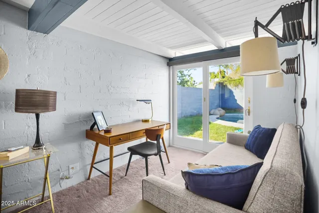 a living room with furniture and a lamp