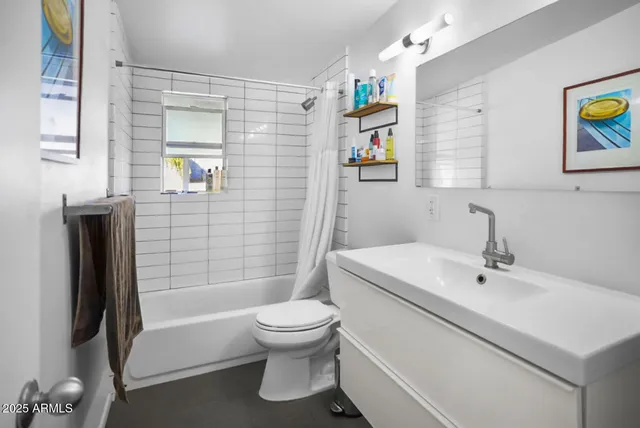 a white toilet sitting next to a bathroom sink