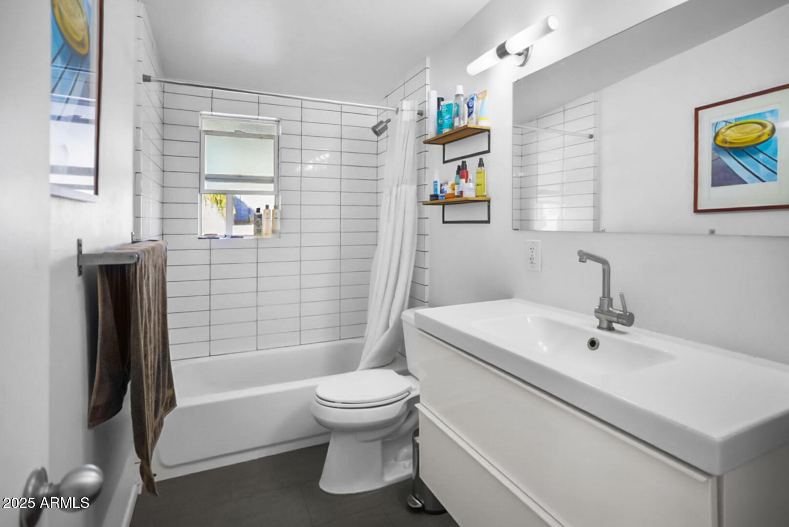 1504 East Rancho Drive Phoenix, AZ 85014 - Photo 8 of 10 a white toilet sitting next to a bathroom sink