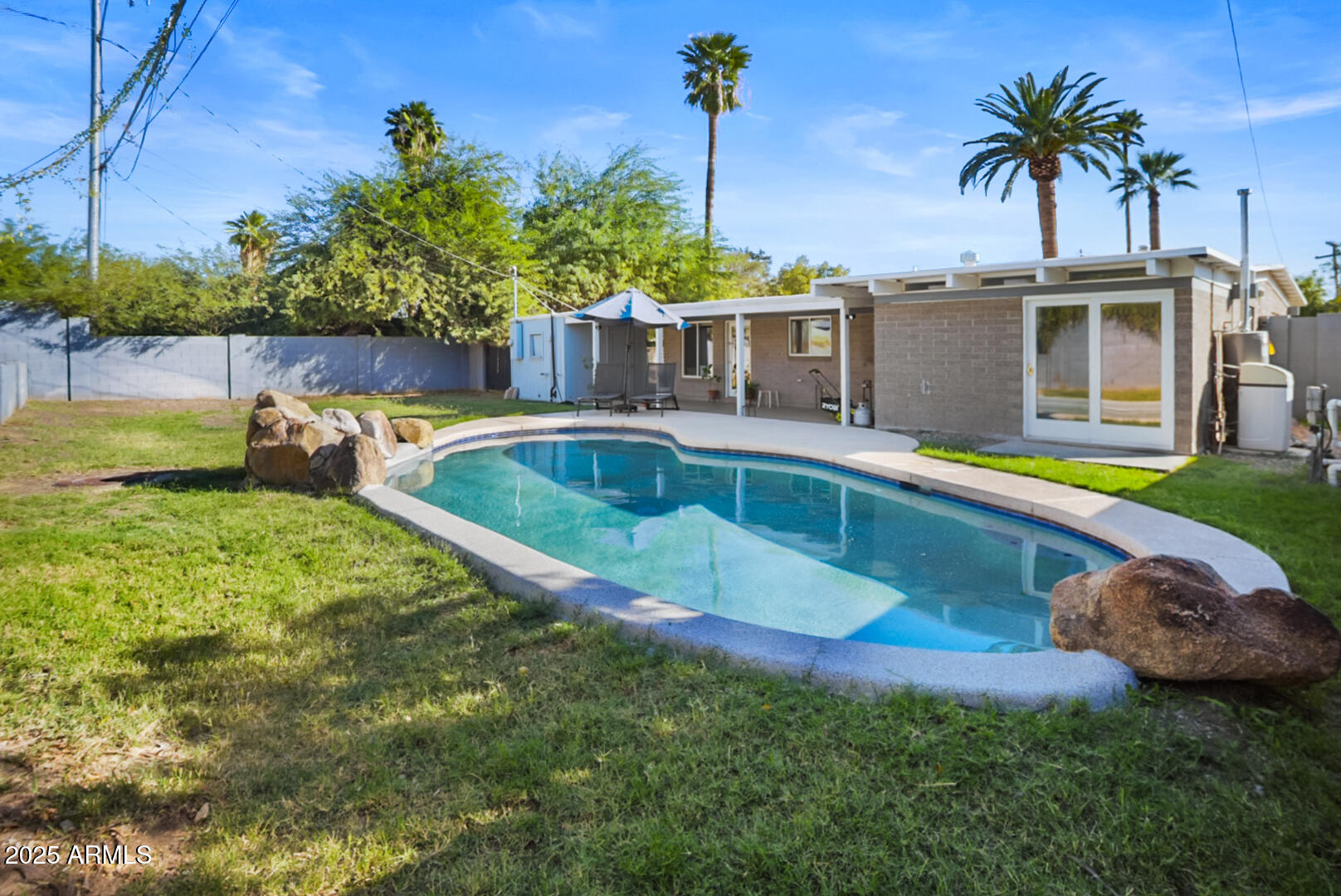 1504 East Rancho Drive Phoenix, AZ 85014 - Photo 10 of 10 a view of a swimming pool with a patio and a yard