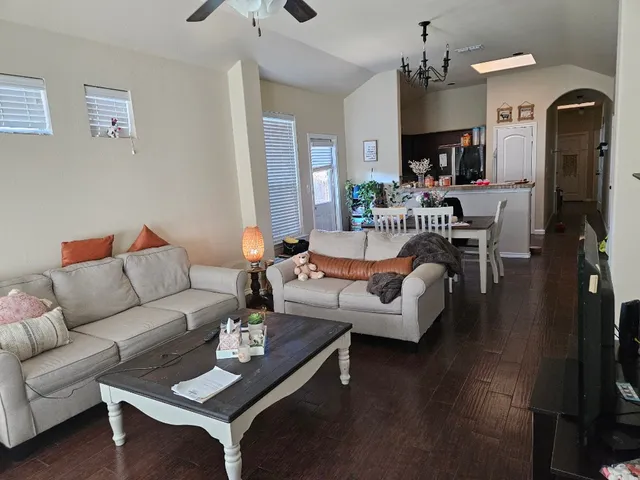 a living room with furniture and a chandelier