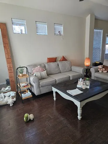 a living room with furniture and wooden floor