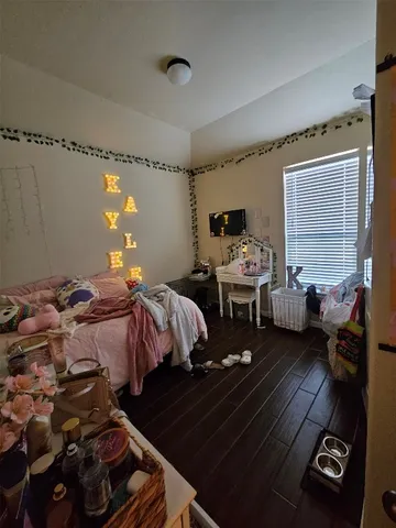 a bedroom with bed and a window