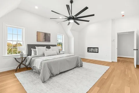 a spacious bedroom with a bed and a chandelier