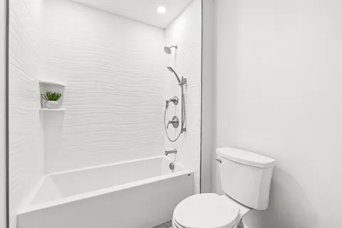 a bathroom with a toilet and a bathtub