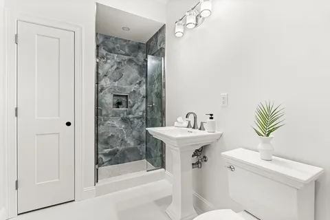 a bathroom with a sink toilet and shower