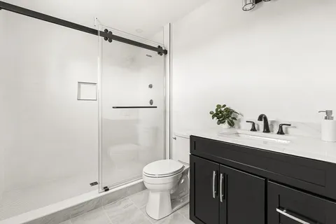 a bathroom with a sink toilet and shower
