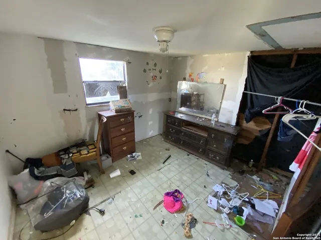 a bedroom with furniture and a window