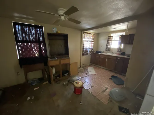 a kitchen that has a lot of cabinets stainless steel appliances and a table