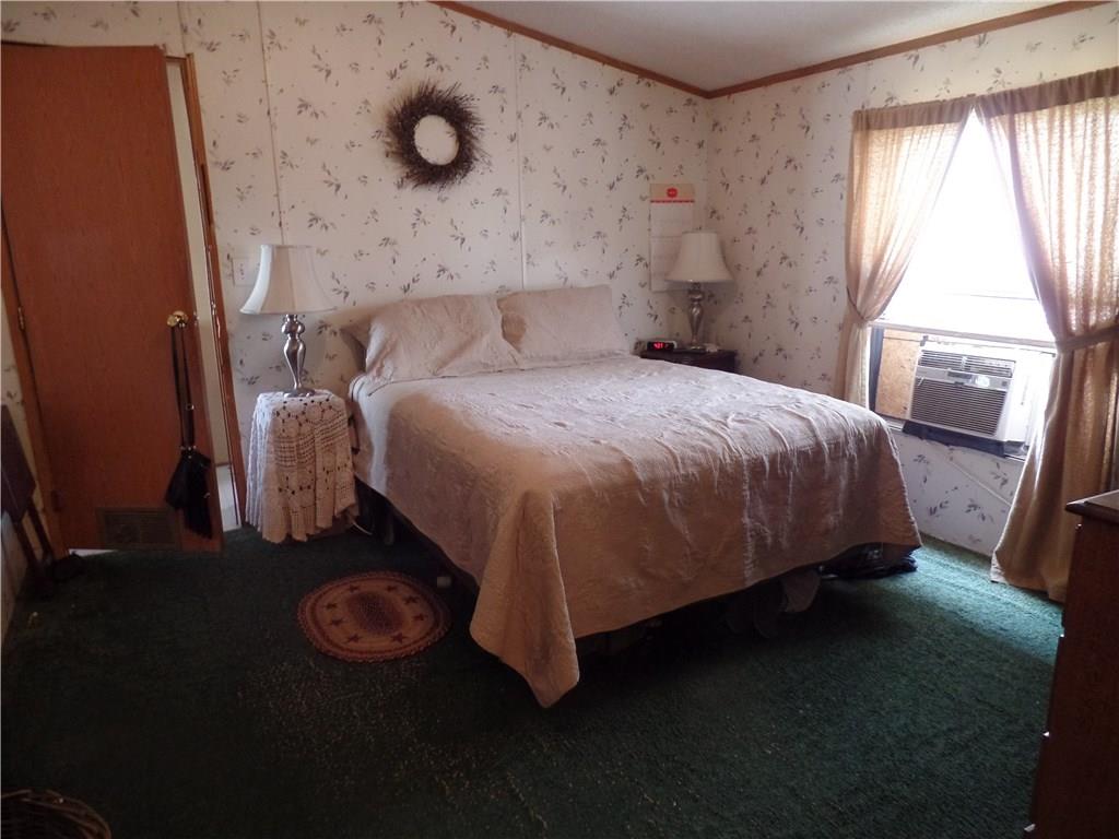 322 Cypress Avenue Rochester, PA 15074 - Photo 10 of 15 a bed sitting in a bedroom next to a window