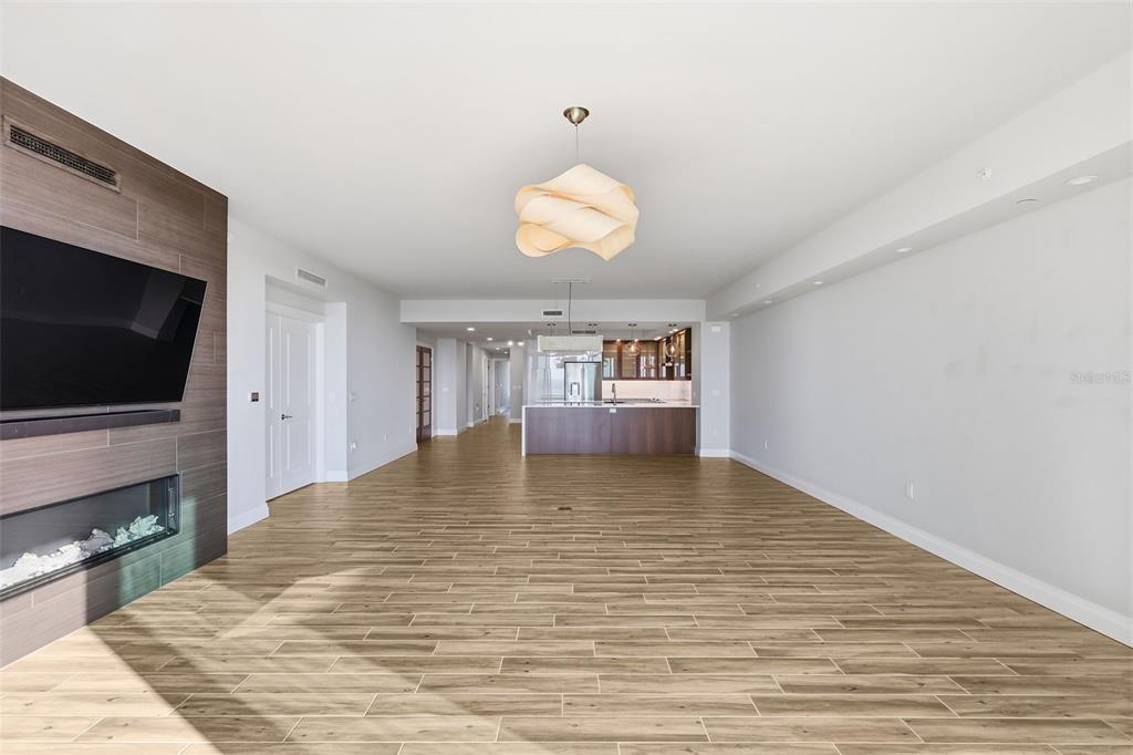 800 Collany Road, Unit 302 St. Petersburg, FL 33715 - Photo 29 of 66 a view of an empty room with a fireplace and wooden floor