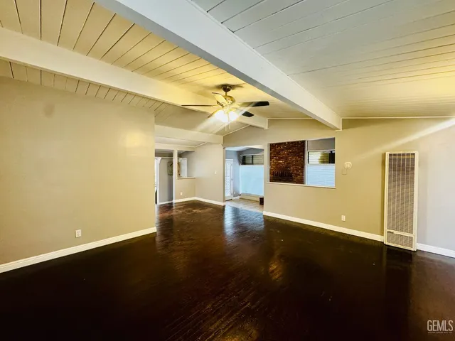 a view of a living room with wooden floor