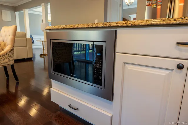 a kitchen with granite countertop a sink and a wooden floor