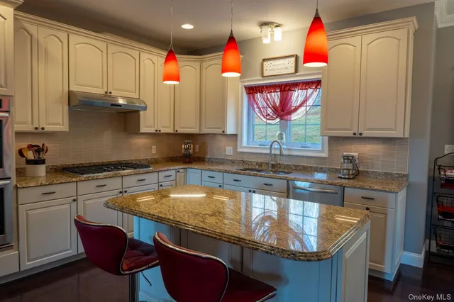a kitchen with a sink appliances and cabinets