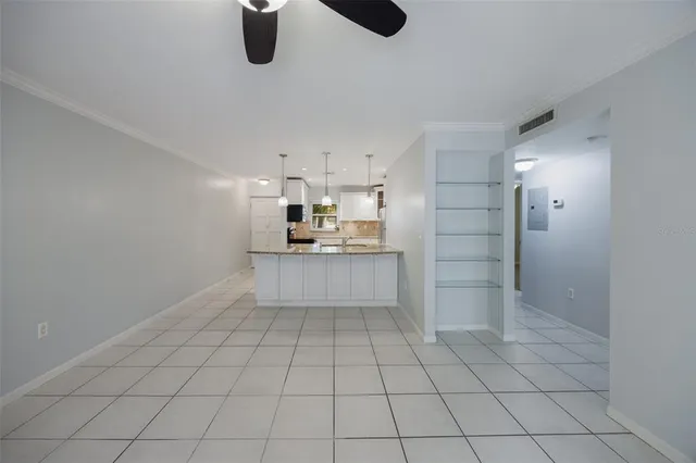 a kitchen with white cabinets and appliances