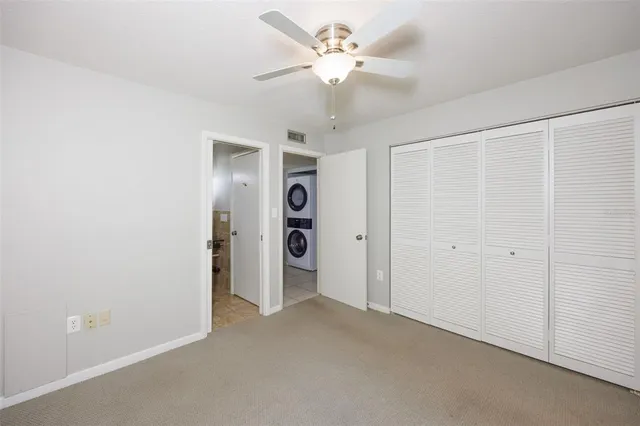 a view of an empty room with a ceiling fan