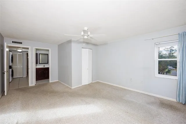 an empty room with windows and cabinet