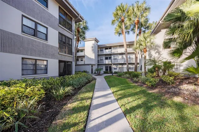 a front view of a building with a garden