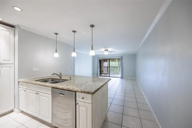 a kitchen with a granite countertop sink and a granite counter tops