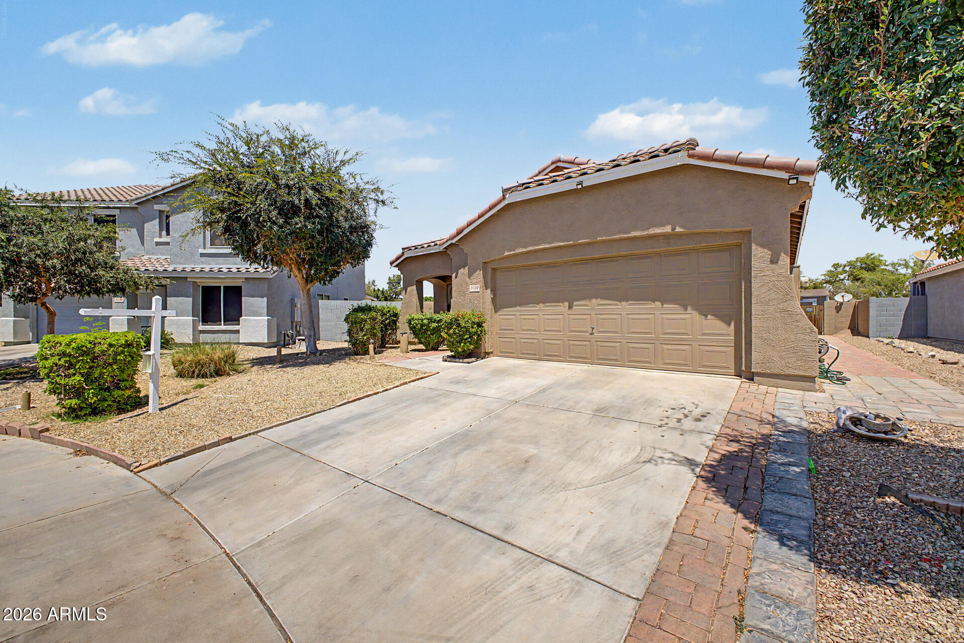 9730 West Payson Road Tolleson, AZ 85353 - Photo 3 of 57 a front view of a house with a yard and garage