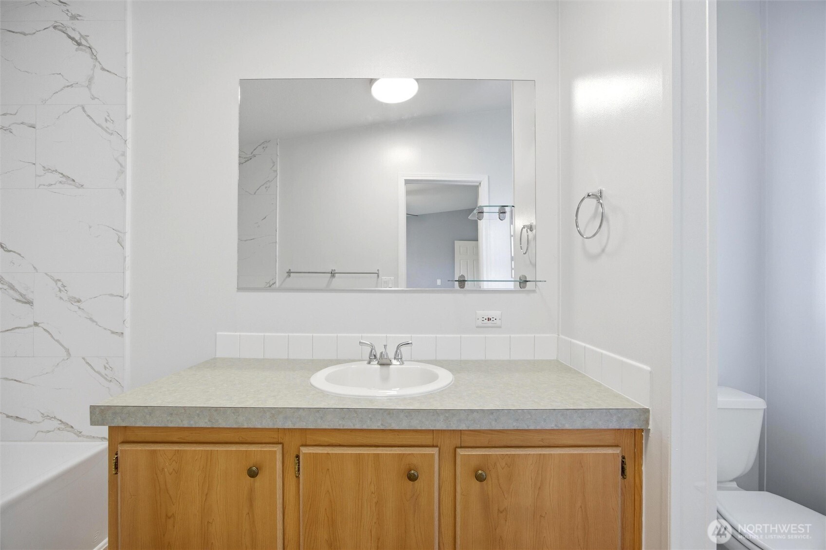 49 Ridgecliff Drive Richland, WA 99352 - Photo 14 of 29 a bathroom with a granite countertop sink a toilet and a mirror