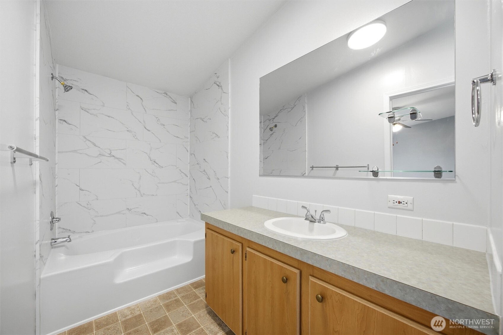 49 Ridgecliff Drive Richland, WA 99352 - Photo 15 of 29 a bathroom with a granite countertop sink a mirror and a bathtub