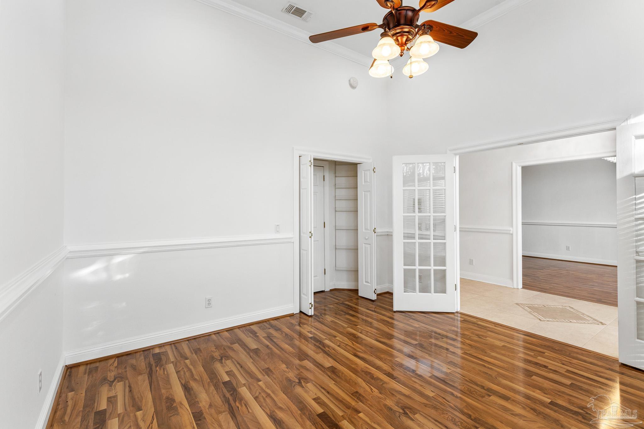 6786 Quintette Road Pace, FL 32571 - Photo 11 of 60 a view of empty room with wooden floor and fan