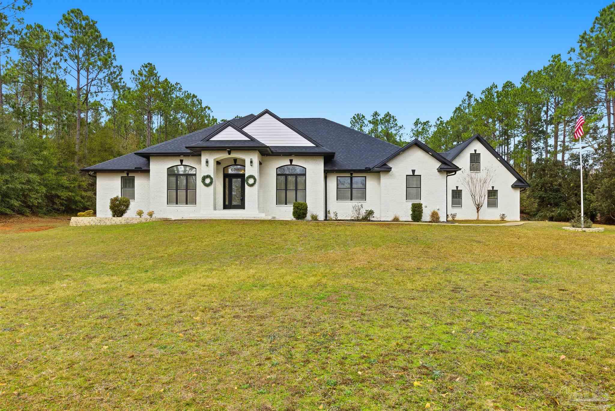 6786 Quintette Road Pace, FL 32571 - Photo 2 of 60 a front view of a house with a yard