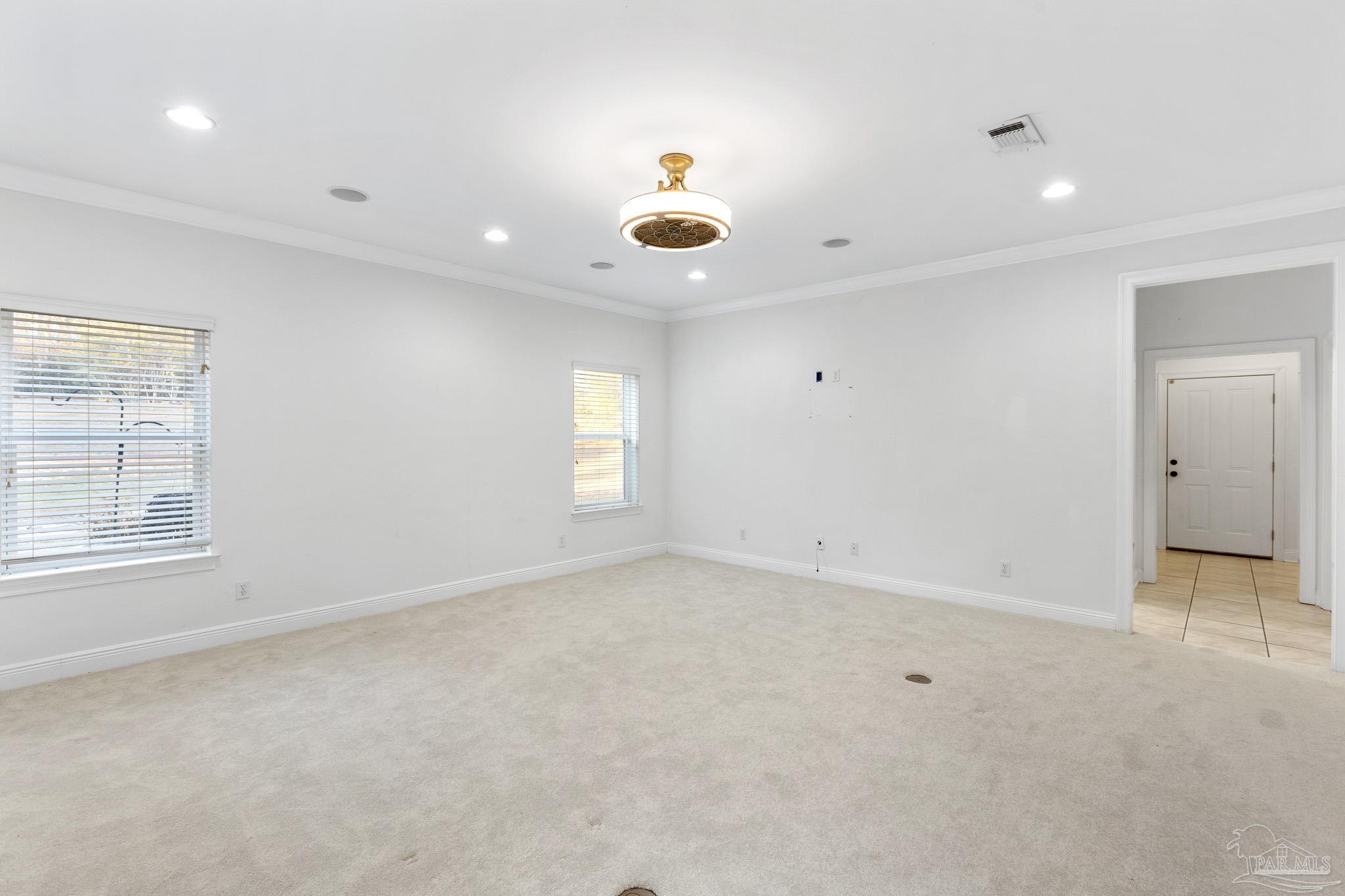 6786 Quintette Road Pace, FL 32571 - Photo 22 of 60 an empty room with windows and cabinet