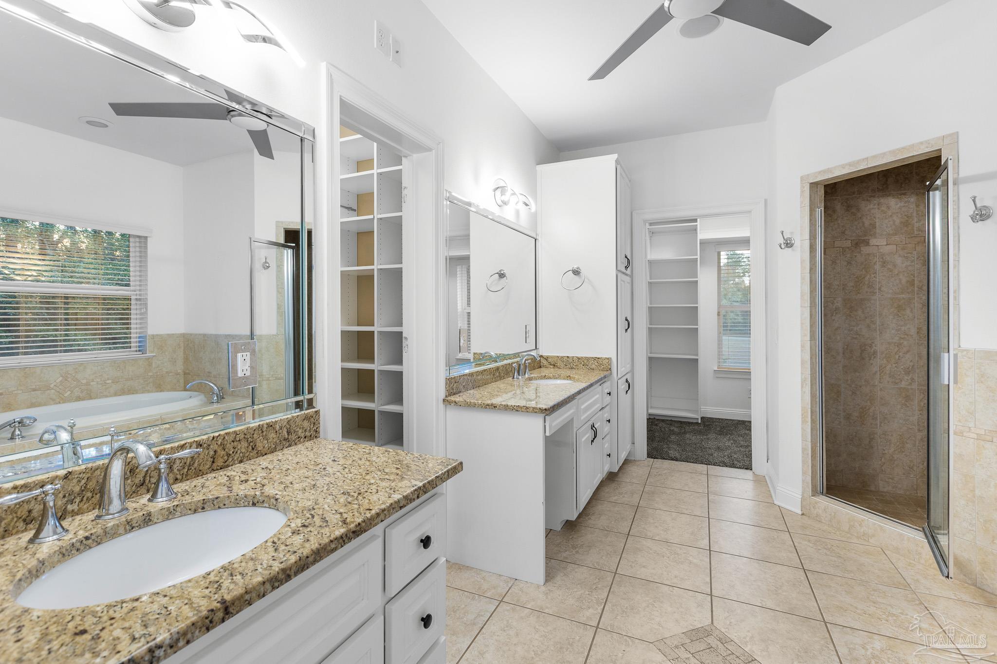 6786 Quintette Road Pace, FL 32571 - Photo 28 of 60 a bathroom with a granite countertop sink a toilet a mirror and shower