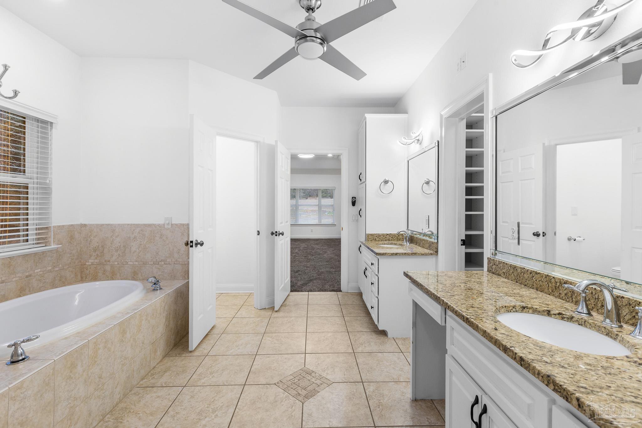 6786 Quintette Road Pace, FL 32571 - Photo 29 of 60 a spacious bathroom with a granite countertop tub sink shower and mirror