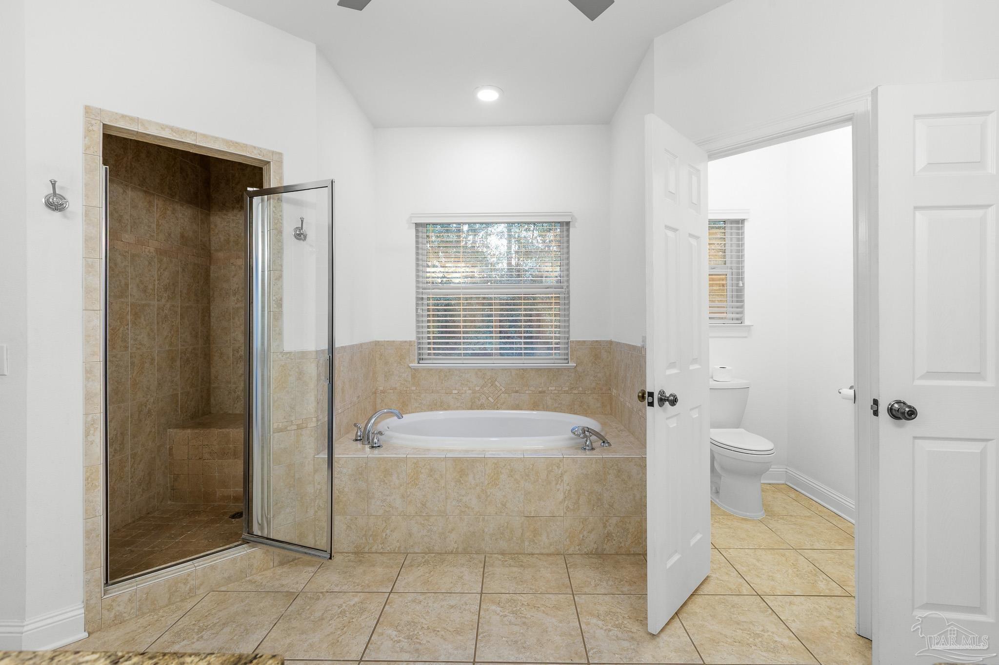 6786 Quintette Road Pace, FL 32571 - Photo 30 of 60 a spacious bathroom with a tub shower and checkered floor