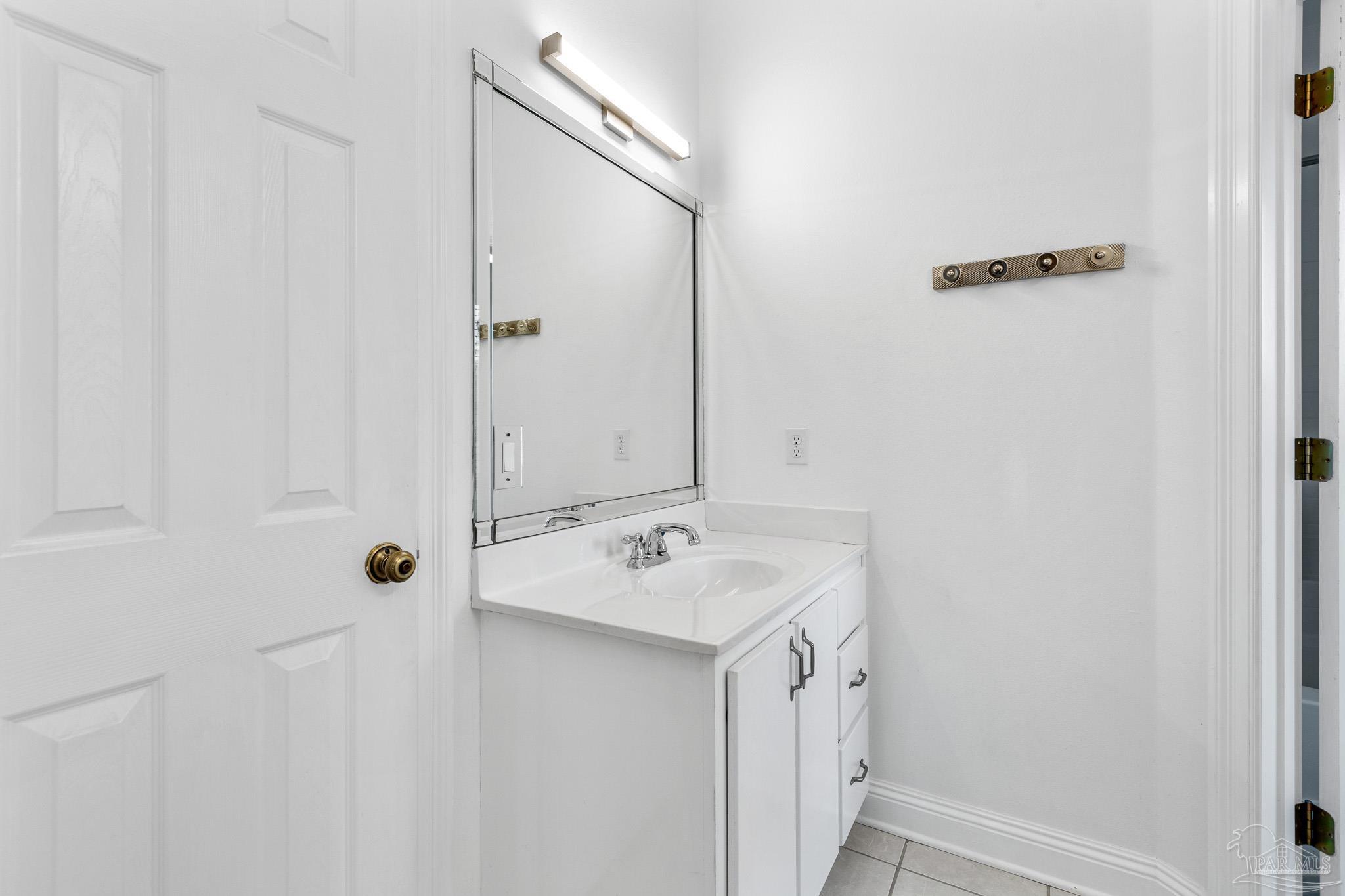 6786 Quintette Road Pace, FL 32571 - Photo 37 of 60 a bathroom with a sink and mirror