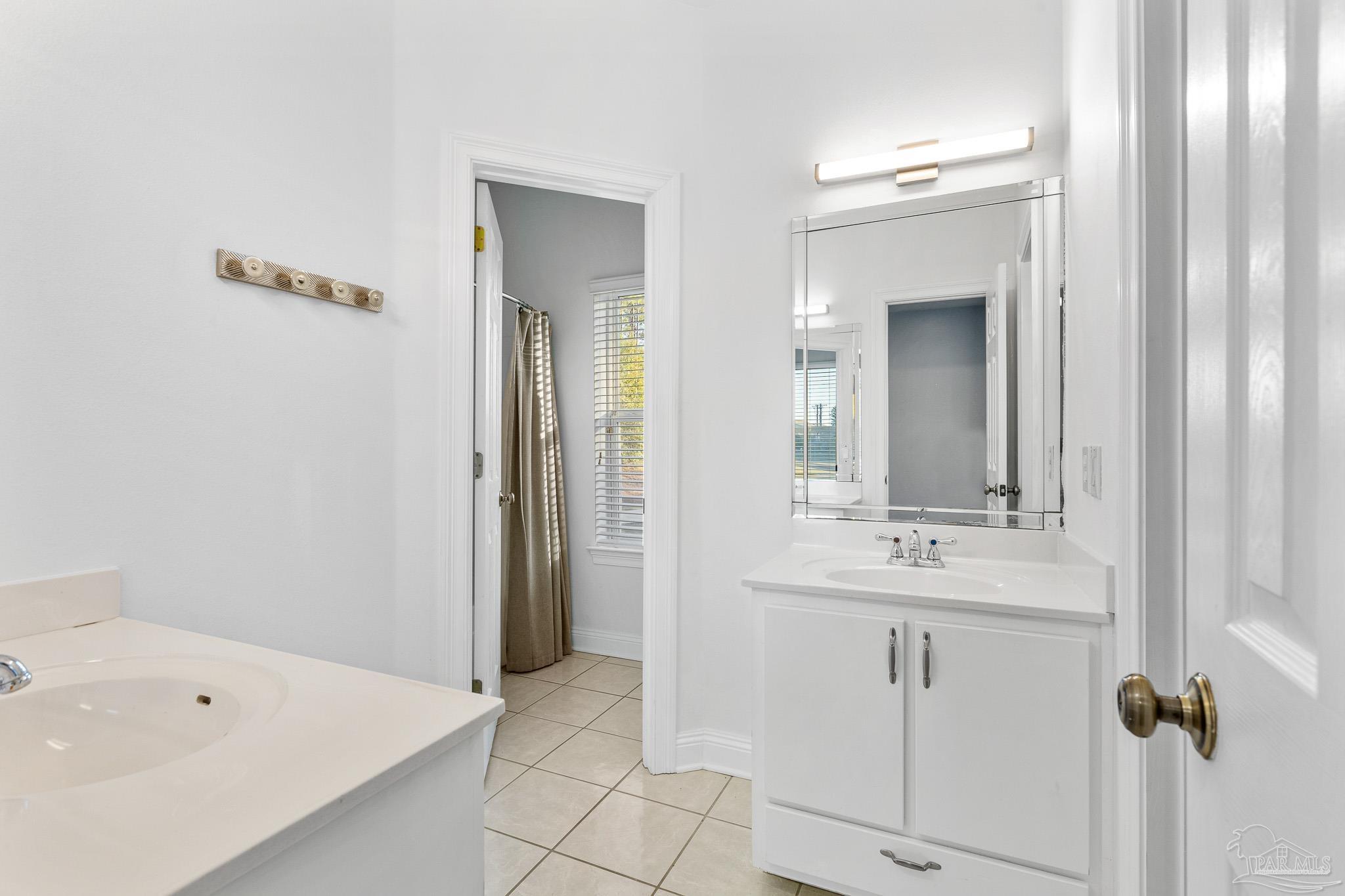 6786 Quintette Road Pace, FL 32571 - Photo 38 of 60 a bathroom with a tub a sink and mirror