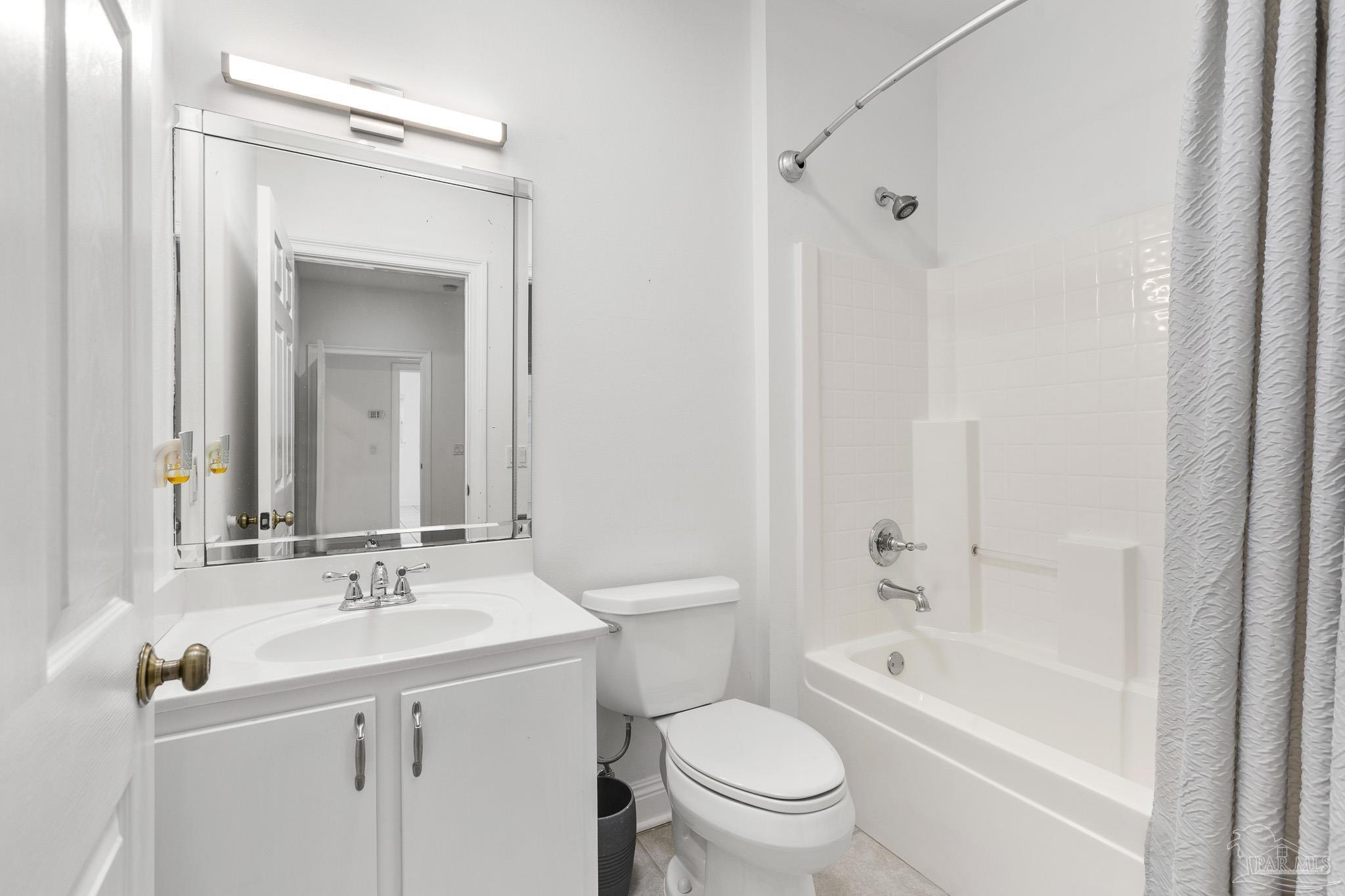 6786 Quintette Road Pace, FL 32571 - Photo 43 of 60 a bathroom with a bathtub shower sink vanity mirror and toilet