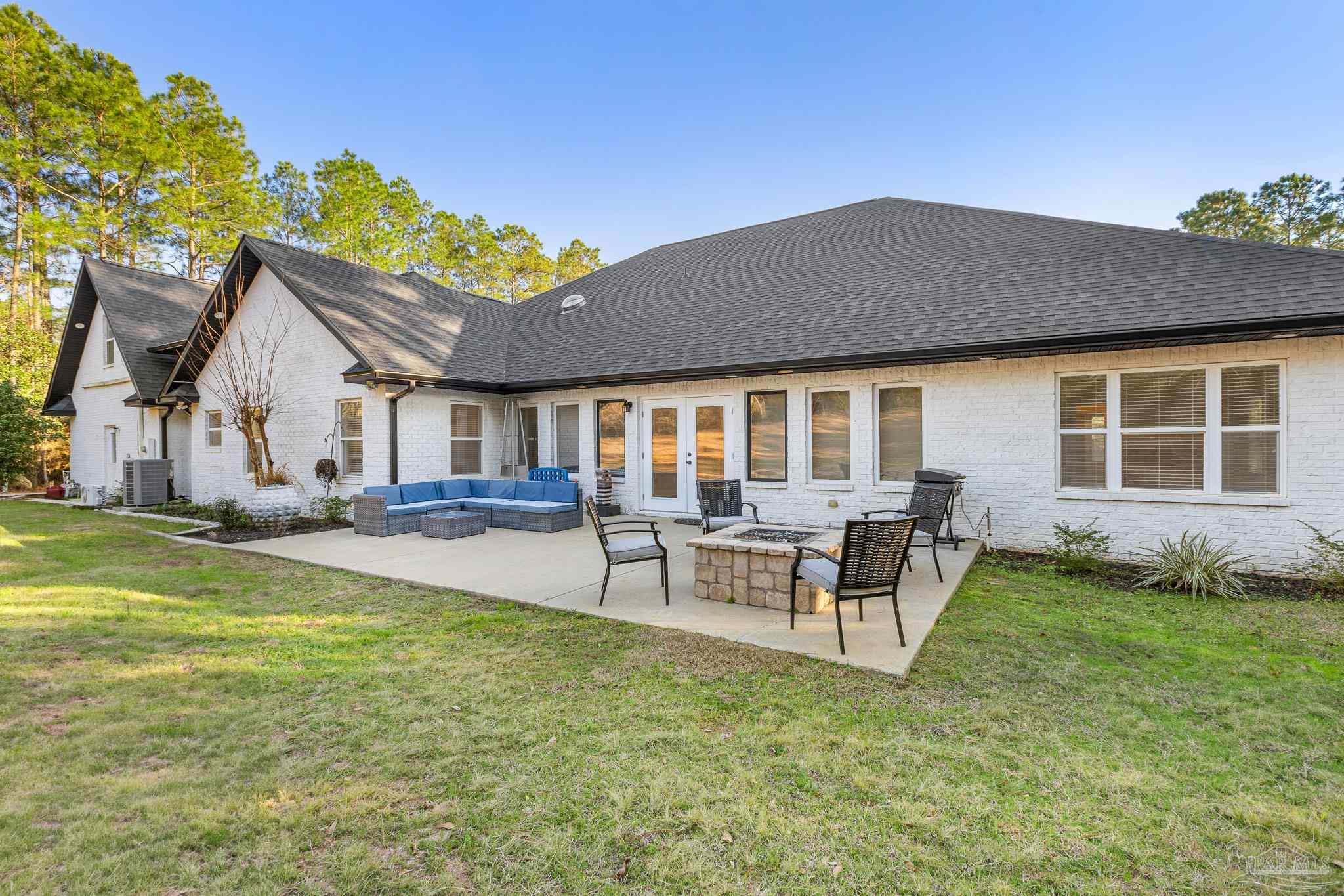 6786 Quintette Road Pace, FL 32571 - Photo 46 of 60 a view of a house with a patio