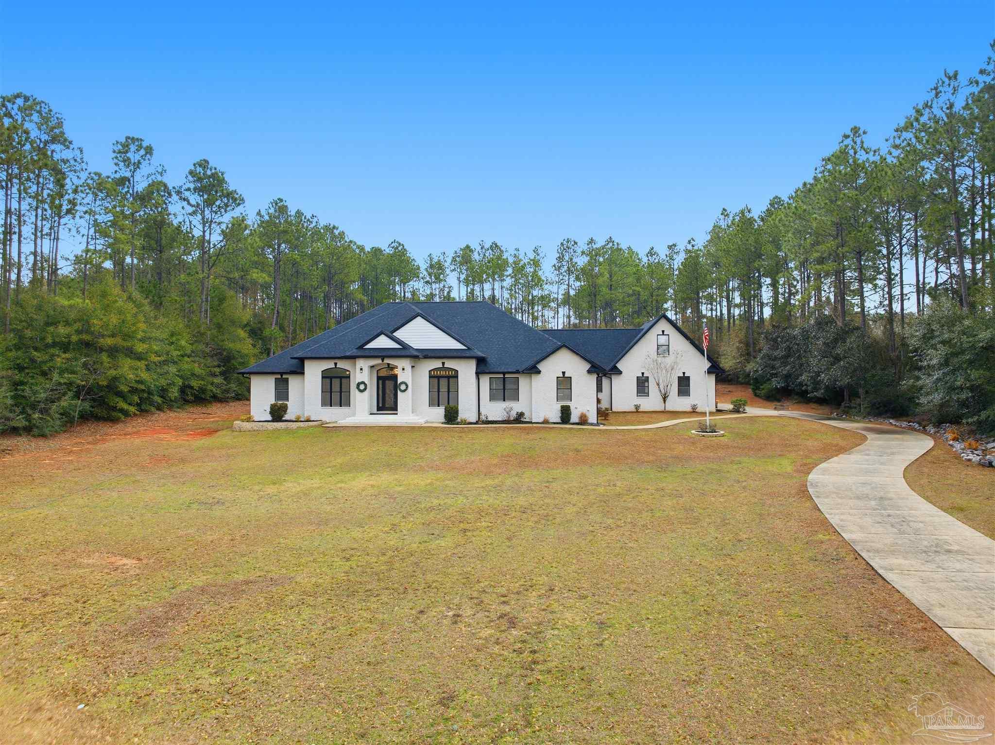 6786 Quintette Road Pace, FL 32571 - Photo 50 of 60 a front view of a house with garden