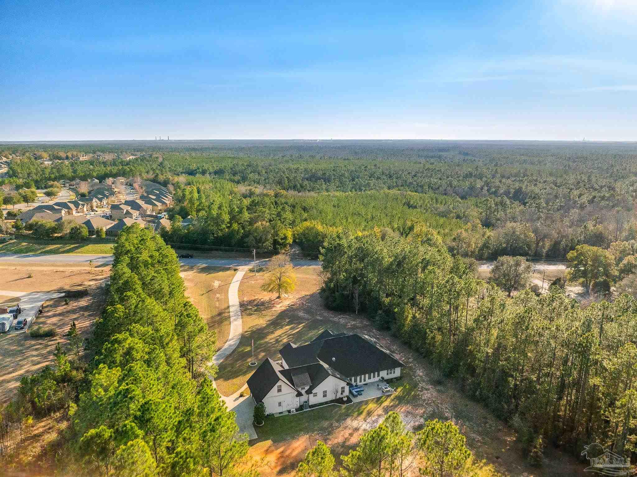 6786 Quintette Road Pace, FL 32571 - Photo 55 of 60 an aerial view of residential houses with outdoor space and river