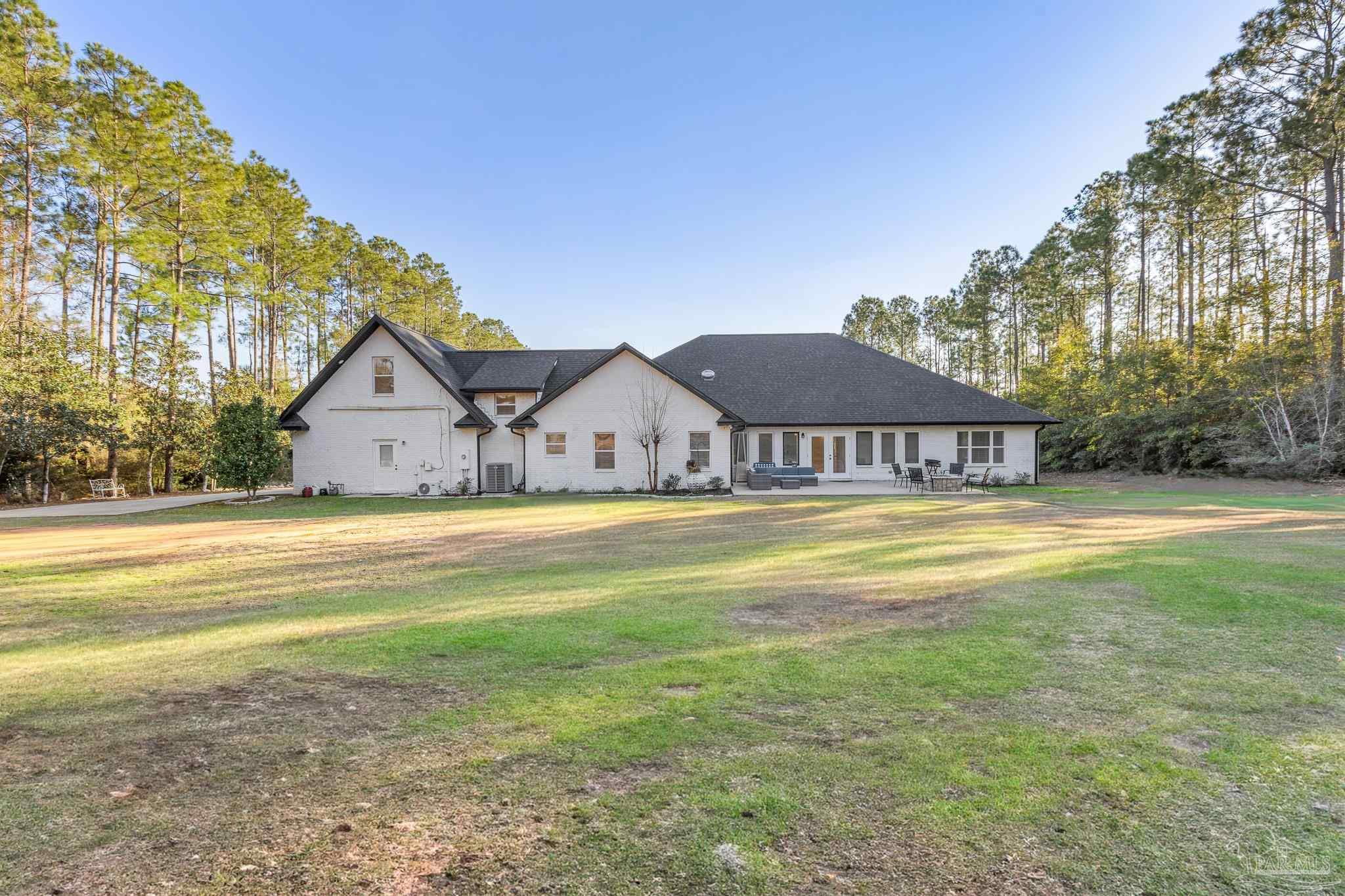 6786 Quintette Road Pace, FL 32571 - Photo 57 of 60 a view of a house with a swimming pool