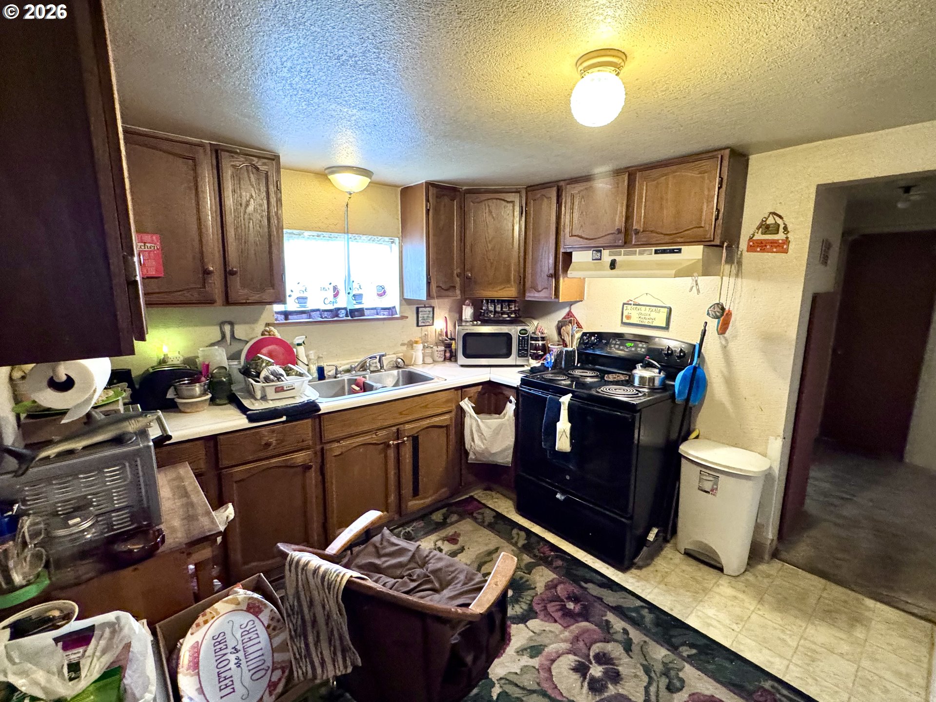 306 4th Street Baker City, OR 97814 - Photo 3 of 11 a kitchen with stainless steel appliances granite countertop a refrigerator stove and sink
