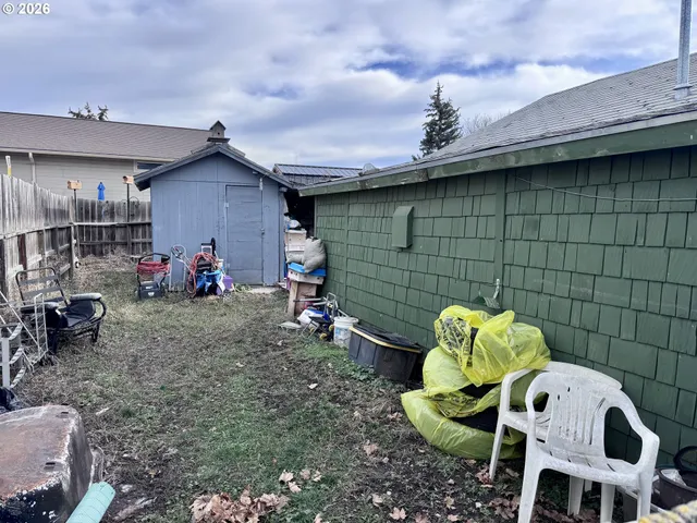 a front view of a house with a yard and potted plants