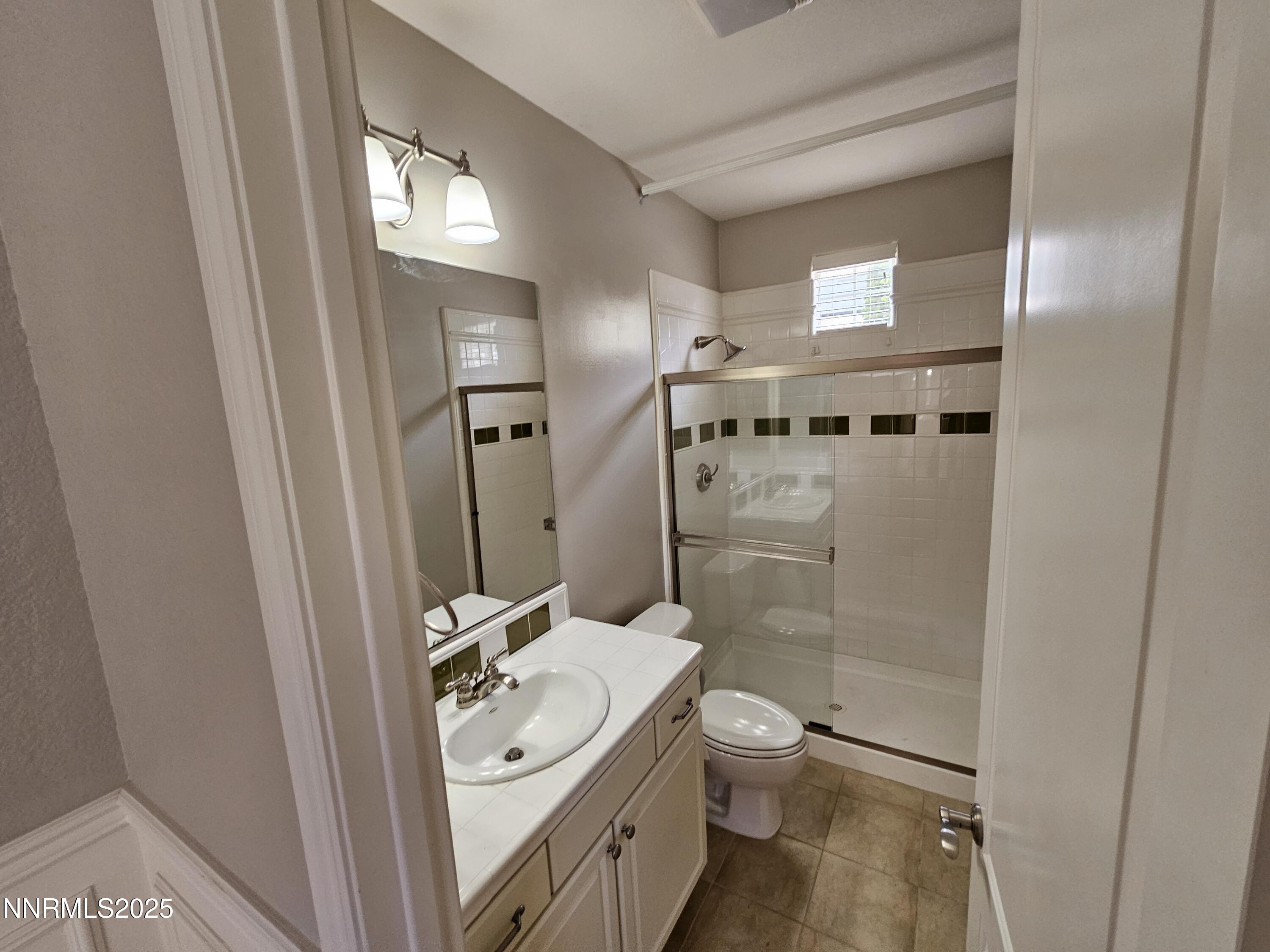 7609 Stone Bluff Way Reno, NV 89523 - Photo 11 of 40 a bathroom with a sink a toilet and shower