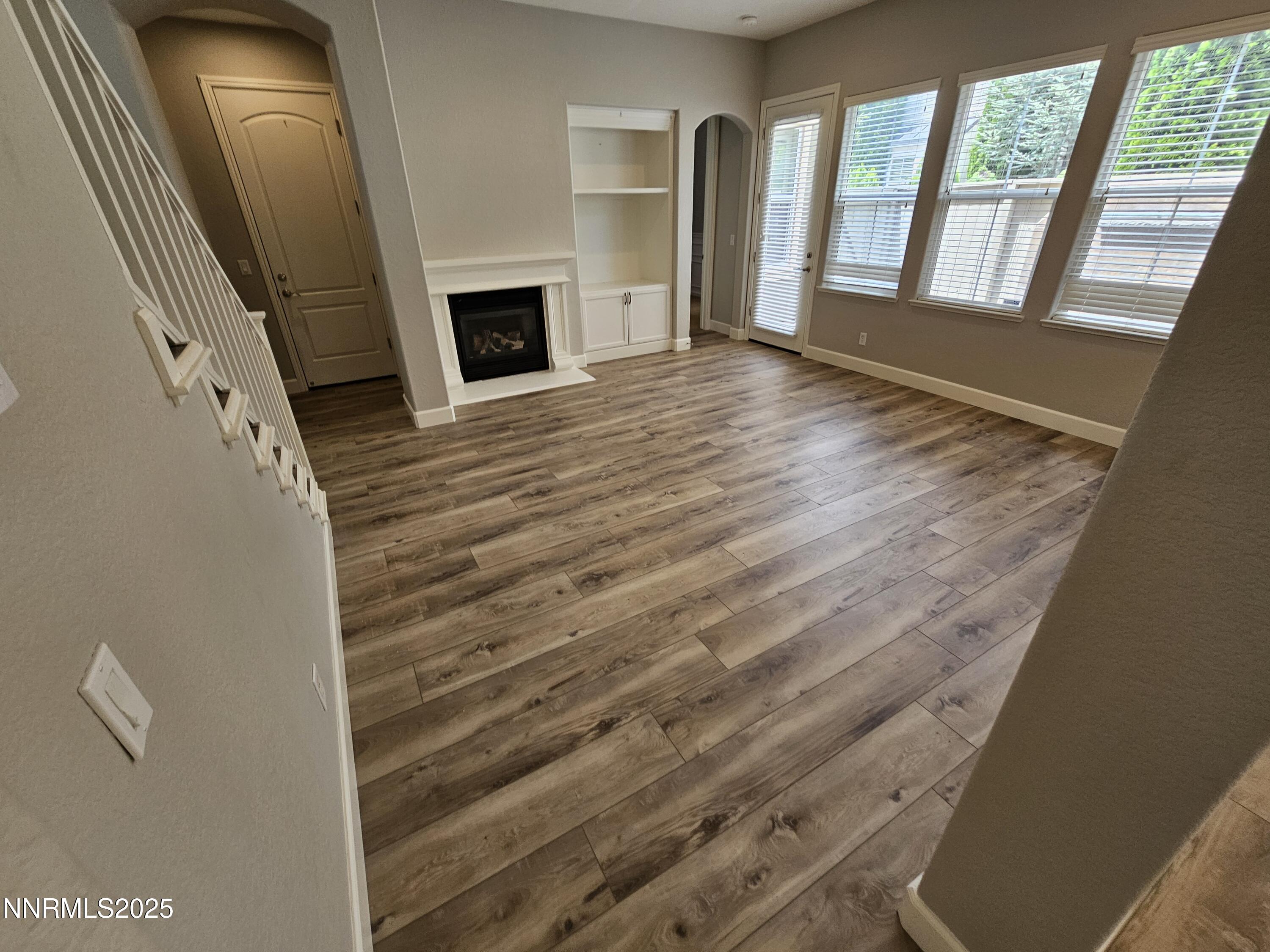 7609 Stone Bluff Way Reno, NV 89523 - Photo 12 of 40 a view of an empty room with wooden floor and a window