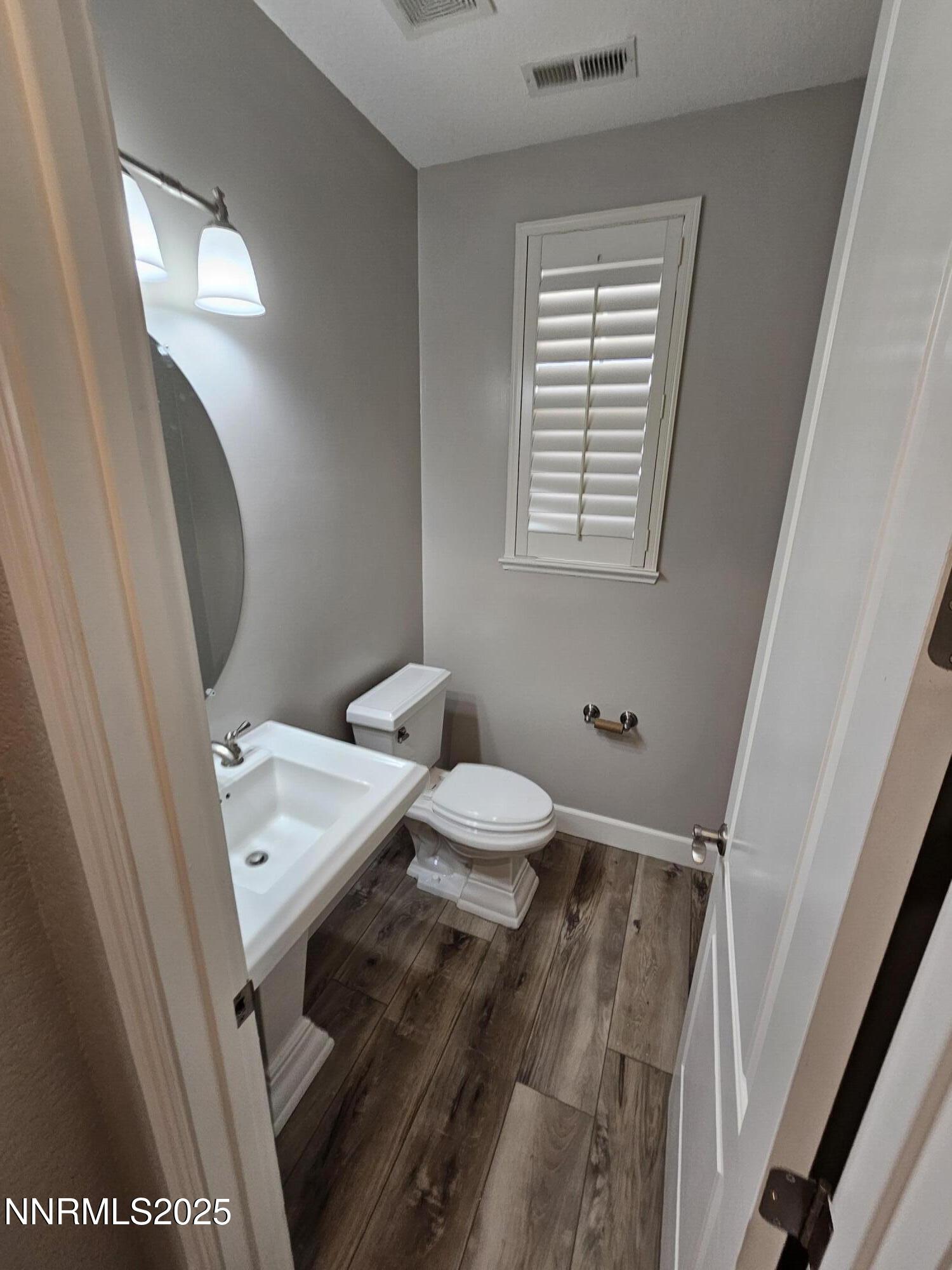 7609 Stone Bluff Way Reno, NV 89523 - Photo 13 of 40 a bathroom with a toilet a sink and a mirror