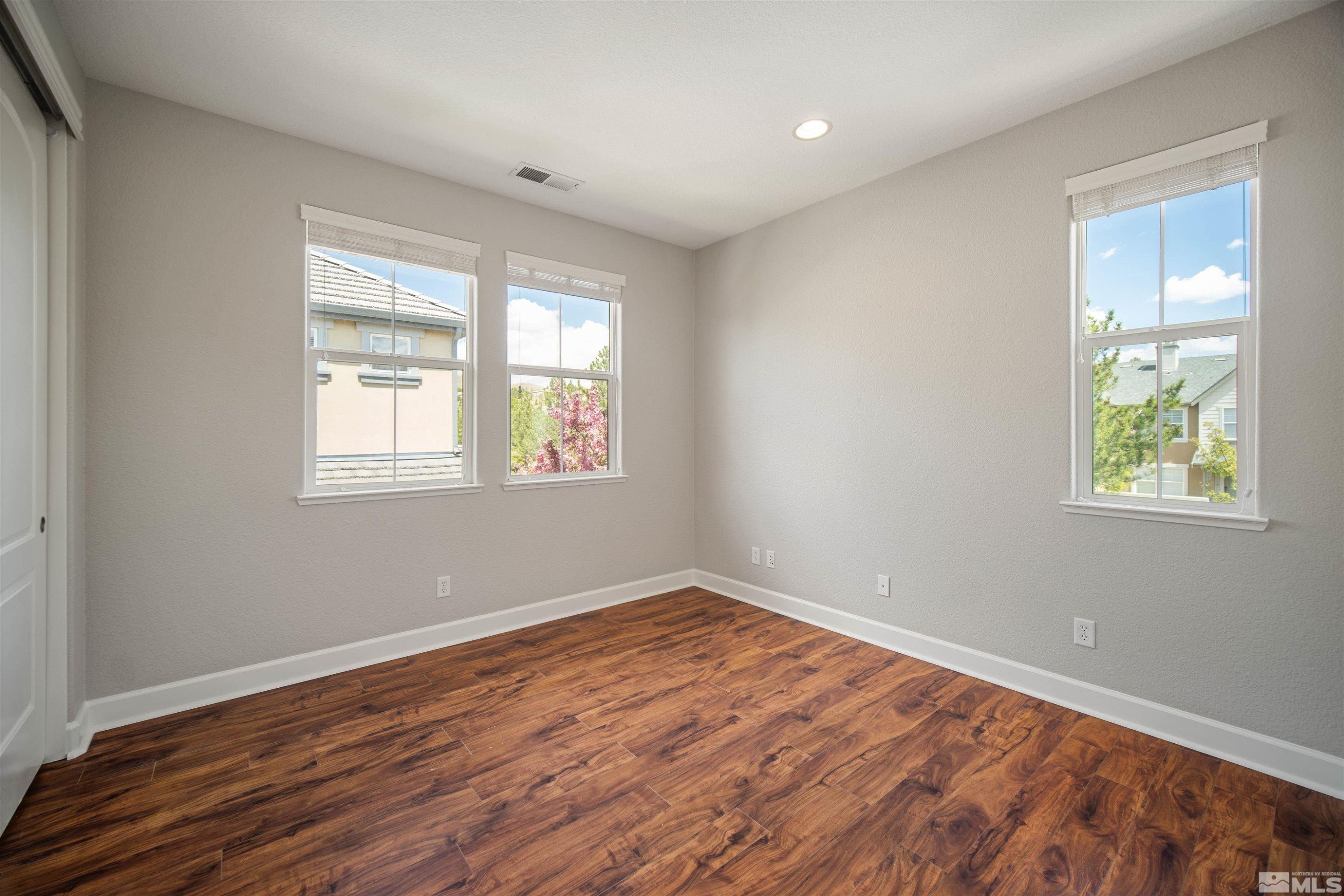 7609 Stone Bluff Way Reno, NV 89523 - Photo 33 of 40 a view of empty room with wooden floor and fan